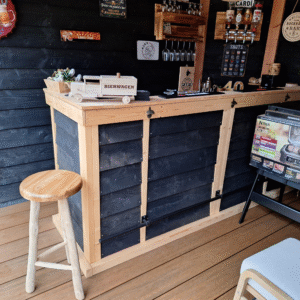 wooden garden shed interior with bar and metal signs